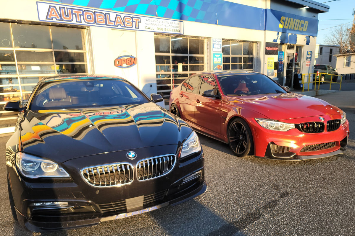 AutoBlast shop exterior with custom BMW vehicles
